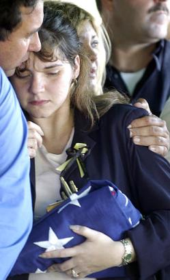 Liudmila Gonzalez, 25, widow of Marine Cpl. Armando Ariel Gonzalez, 25, of Hialeah, is hugged by her late husband's best friend, Vladimir Diaz, left, Tuesday, April 29, 2003, in Hialeah, Fla., during the funeral of her late husband.