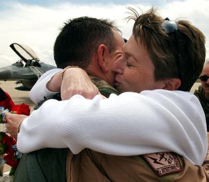 Colorado Air National Guard Col. John Mooney, of Denver, is greeted by his wife Kelly, right, as he arrives at Buckley Air Force Base near Denver, Wednesday, April 30, 2003.